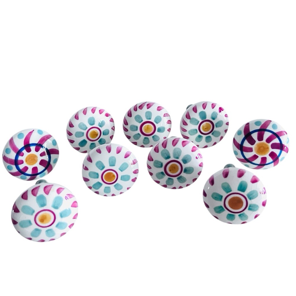 Set of 11 hand-painted ceramic knob pulls. 1.5” wide x 1” deep.